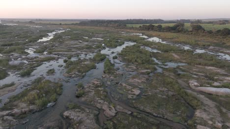 El-Río-Cocodrilo-Estacional-Esparce-Agua-Sobre-Terreno-Pedregoso-Con-Hierba-Alta