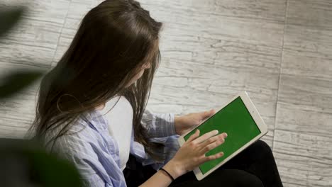 woman holds tablet in the hands during rest at work