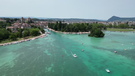 boat leaving harbour on lake annecy france reverse drone , aerial, 4k footage