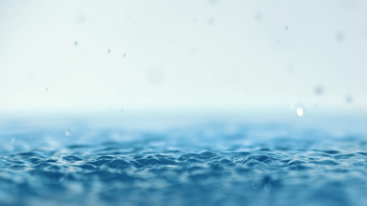 Rain water drops falling in super slow motion.