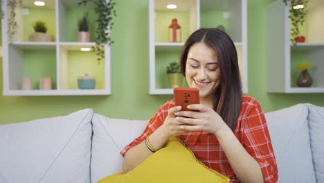 Cheerful-and-happy-young-woman-texting-on-the-phone.