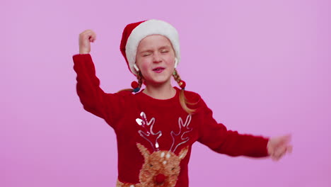 Girl-in-Christmas-sweater-listening-music-via-earphones,-dancing-disco-fooling-around-having-fun