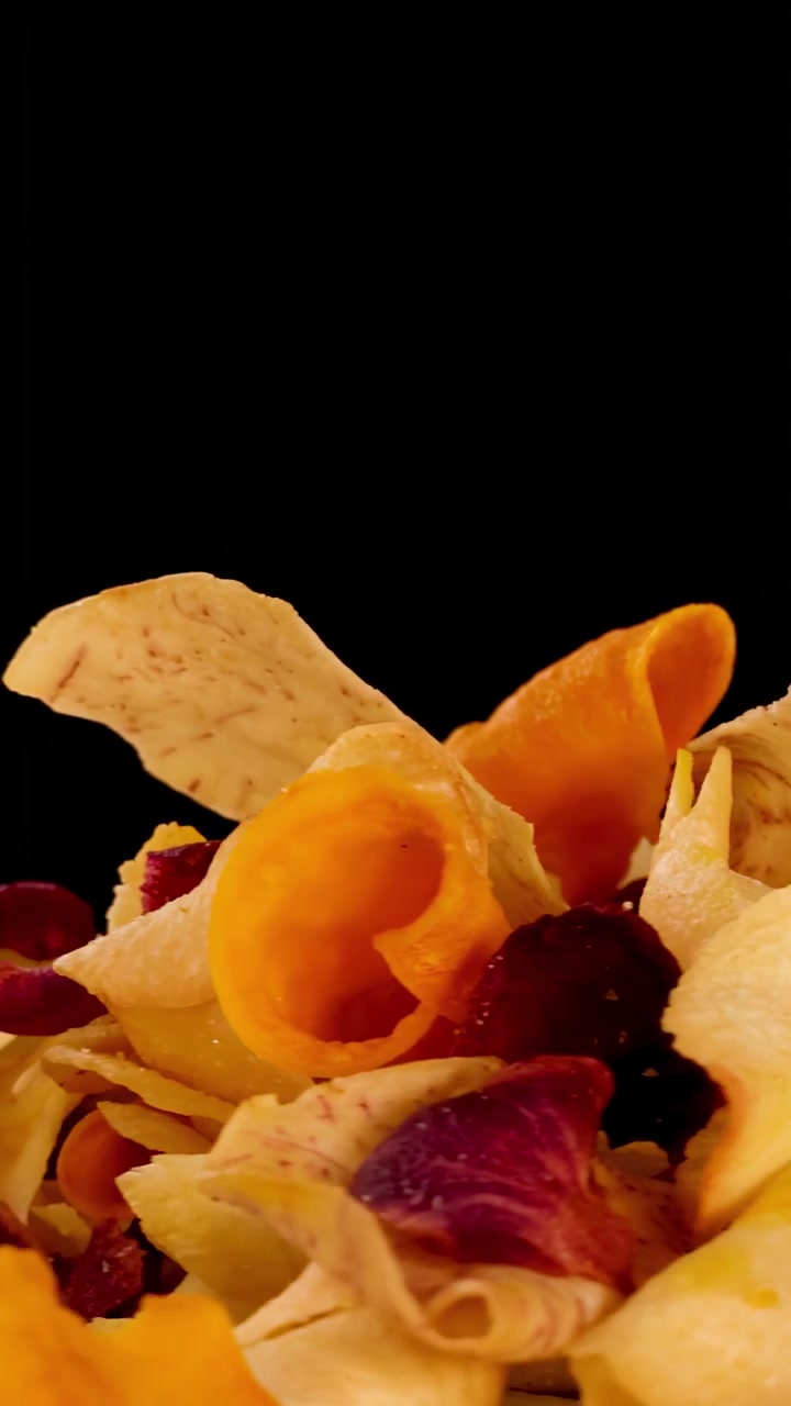 Hand Picking Up a Crispy Root Vegetable Chip