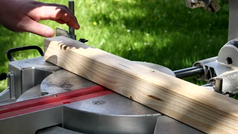 slow motion. sawing a wooden panel with a miter saw