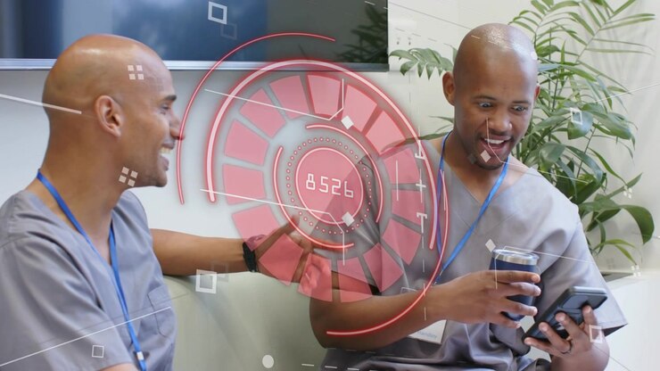 Healthcare staff duo sitting on couch, right man glancing phone causing red HUD sharing stats