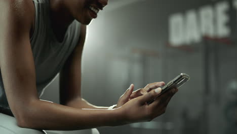 woman using mobile phone at the gym