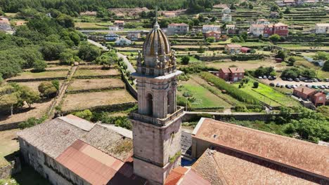 drone view circling the bell tower of the monastery of oia in santa maria de oya