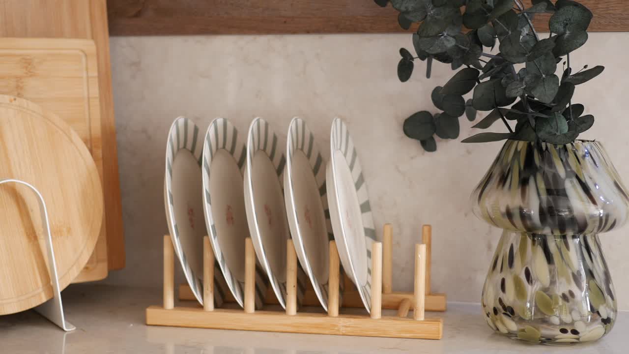 Still life with plates, cutting boards, and eucalyptus