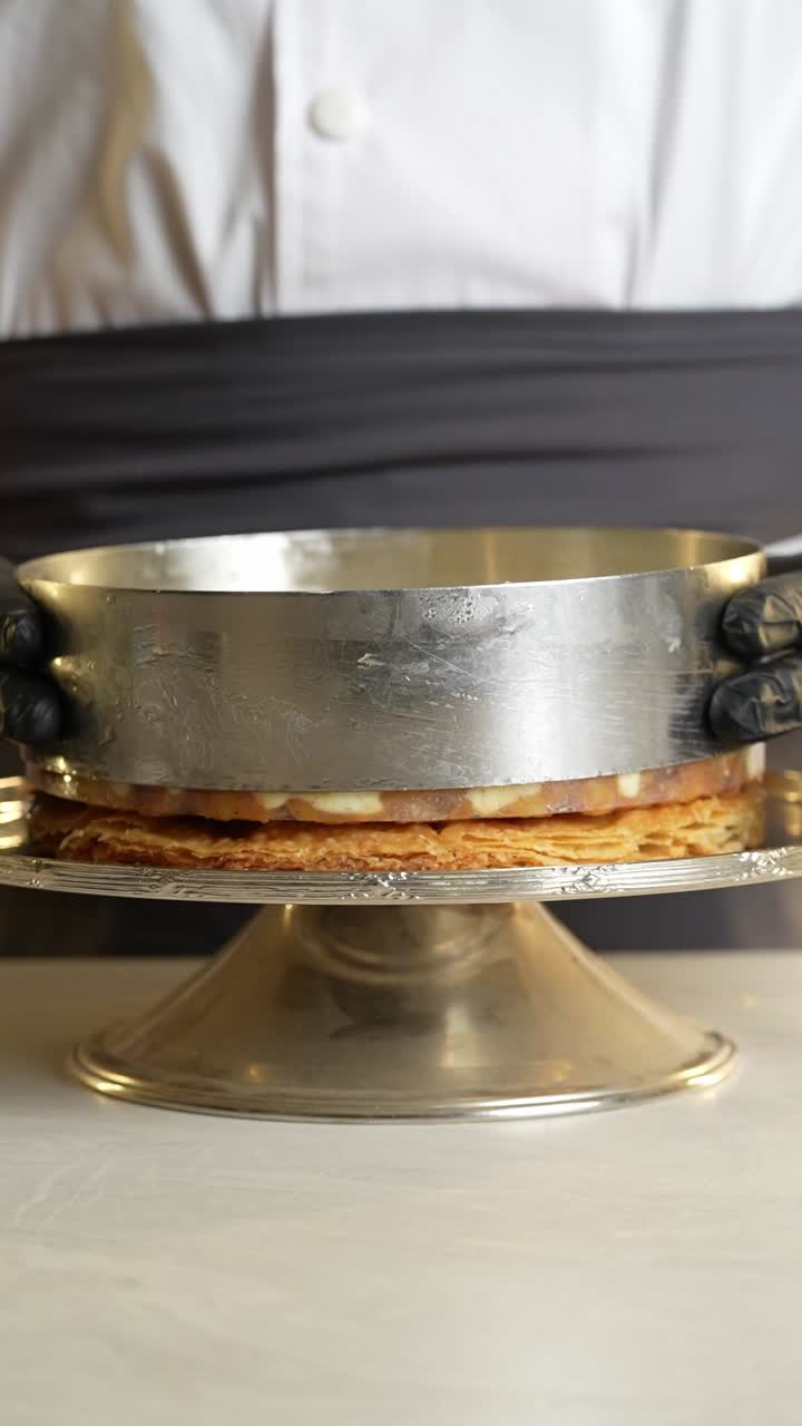 A chief prepares a cake with sweets, close up shot,