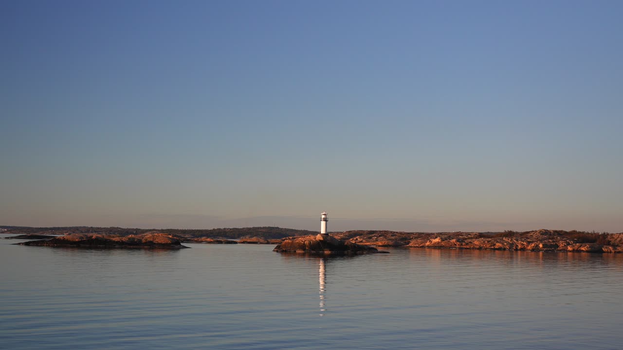 Ursholmen Lighthouse golden hour Arctic sunlight sunset ferry boat ride Scandinavia islands Ytre Hvaler National Park Strömstad Stromstad Oslo Fjord Sweden Sverige Norway Norge parallax right motion