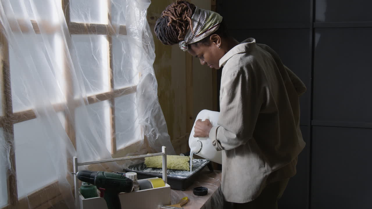 Woman Painting with Roller and Drill