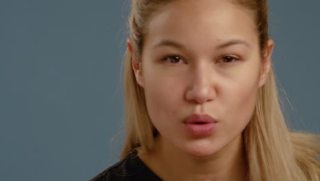 cu young woman blows a kiss to camera