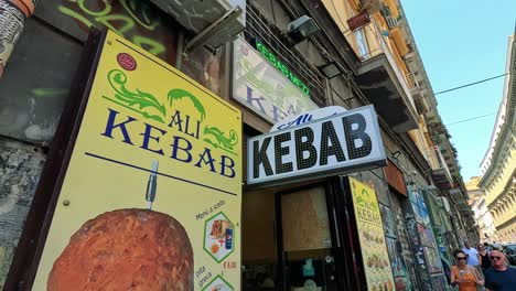 kebab shop sign in a busy naples street