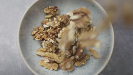 healthy organic walnuts, marco close up. healthy vegetarian vegan raw nuts, slo motion of walnuts falling into bowl