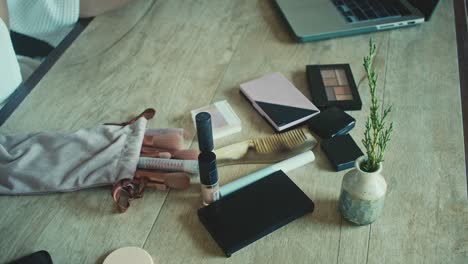 makeup and beauty products on wooden desk