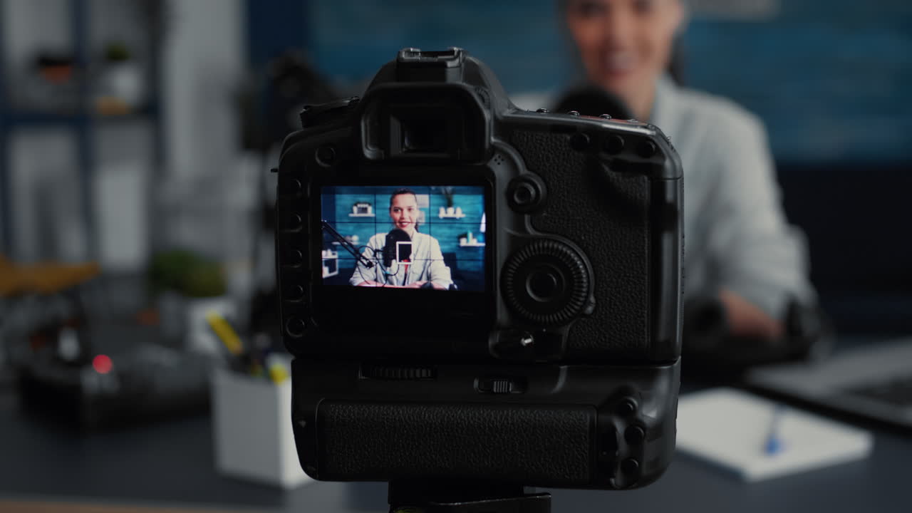 Professional camera recording social media influencer daily vlog while talking to audience