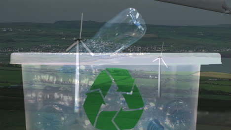 animación de un cartel de reciclaje verde sobre una caja con botellas de plástico y una turbina eólica