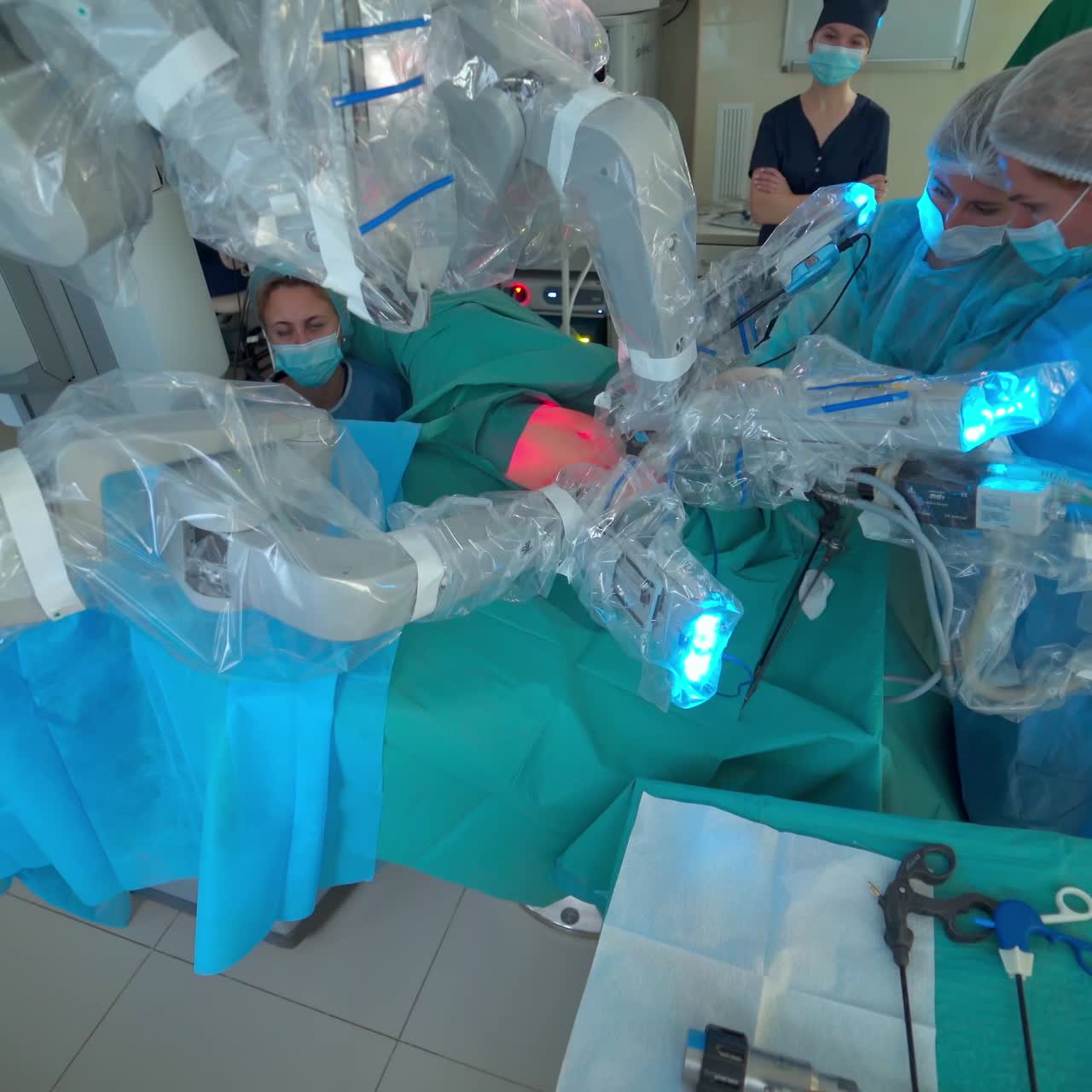 Surgeons in room with medical equipment. Doctor using sterile medical equipment during surgery