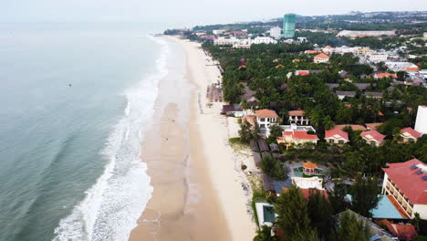 Aerial-flying-backwards-of-Ham-tien,-kitesurfing-mecca-of-Asia