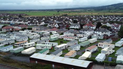 colourful static caravan trailer beachfront staycation holiday home campground resort aerial view low orbit right