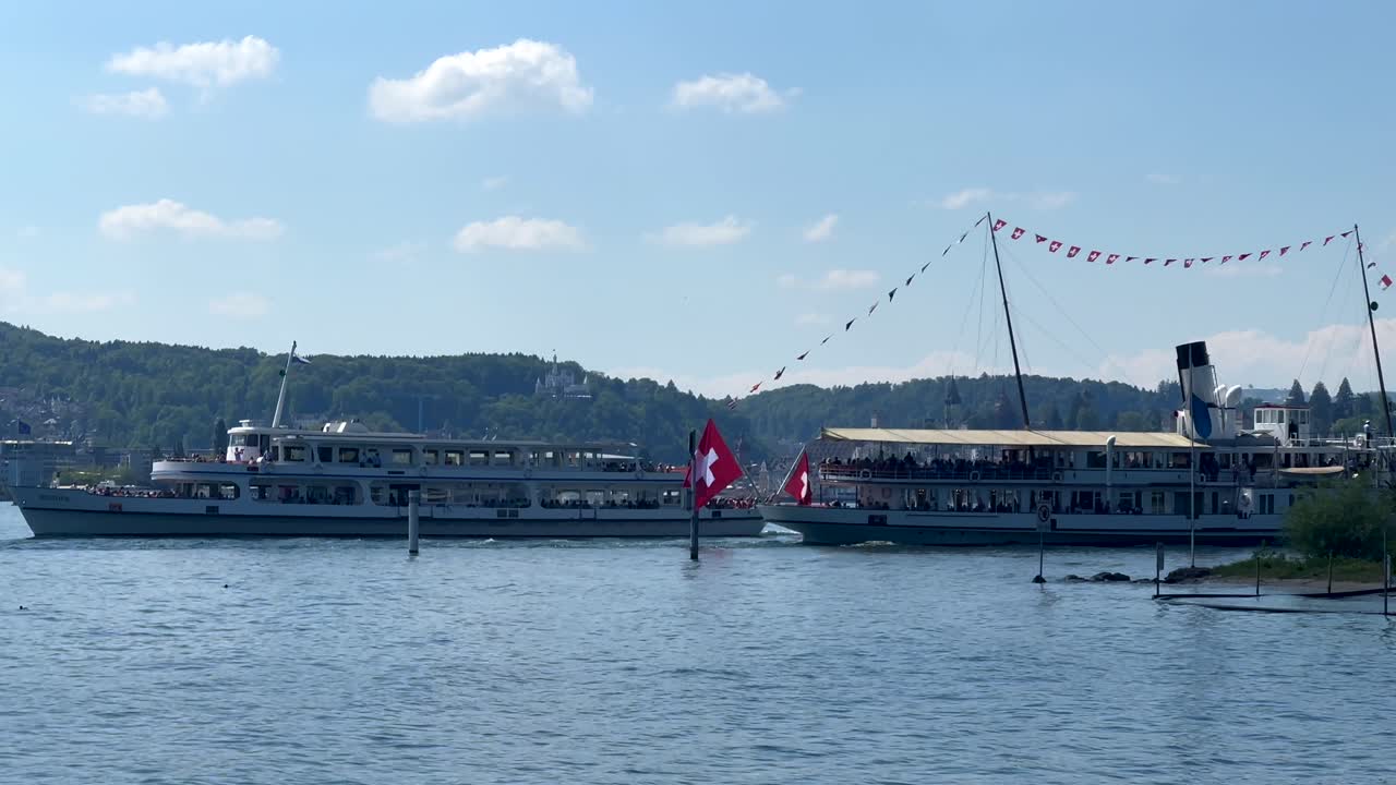 Ferry ship and boat on swiss lake with flag during sunny day in summer. Wide shot. Visiting Beautiful Natur of Switzerland.