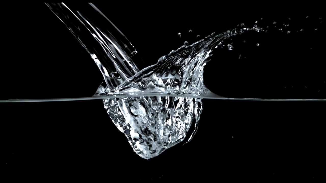 Slow Motion Clear Water Pouring and Splashing on Black Background