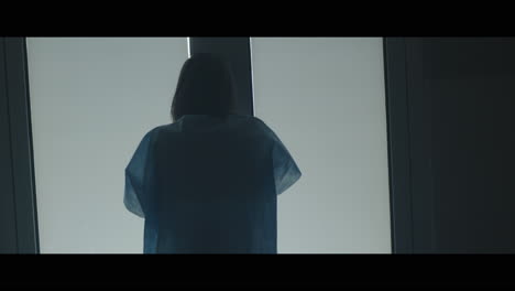a girl runs through strange corridors of abandoned hospital