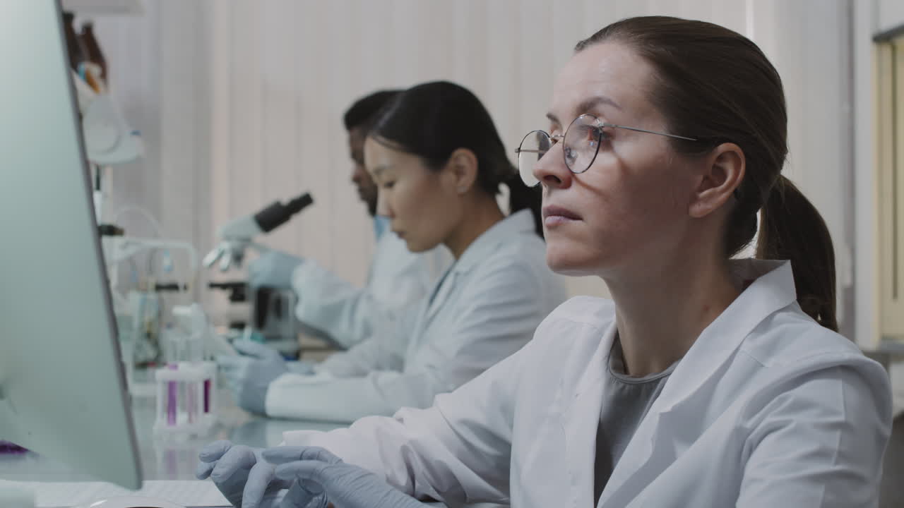 Female and Male Scientists Doing Research in Lab