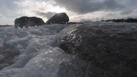 water level view of waves crashing and rolling into shore in slow motion 1