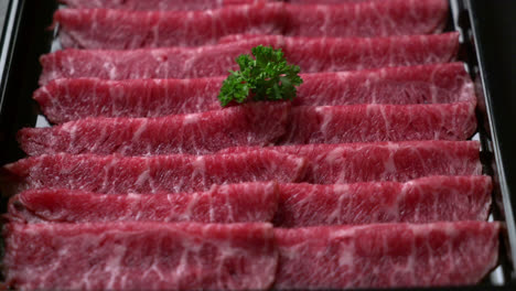 fresh beef raw sliced with marbled texture served for sukiyaki and shabu or yakiniku