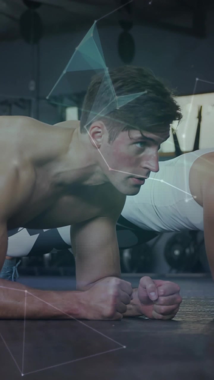 Vertical video: Man and woman holding elbow plank in gym, nodes, globe fading over core for fitness