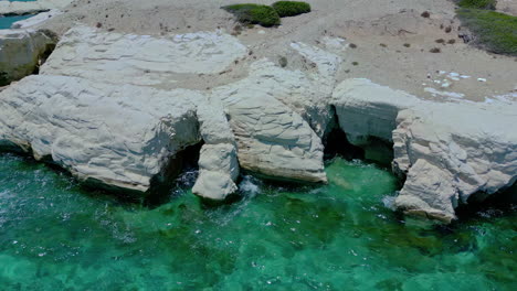 Aerial-Top-Down-Timelapse:-Seawaves-Crashing-Against-the-Rocky-Coastline-of-white-rocks,-cyprus,-an-Exhilarating-Coastal-View