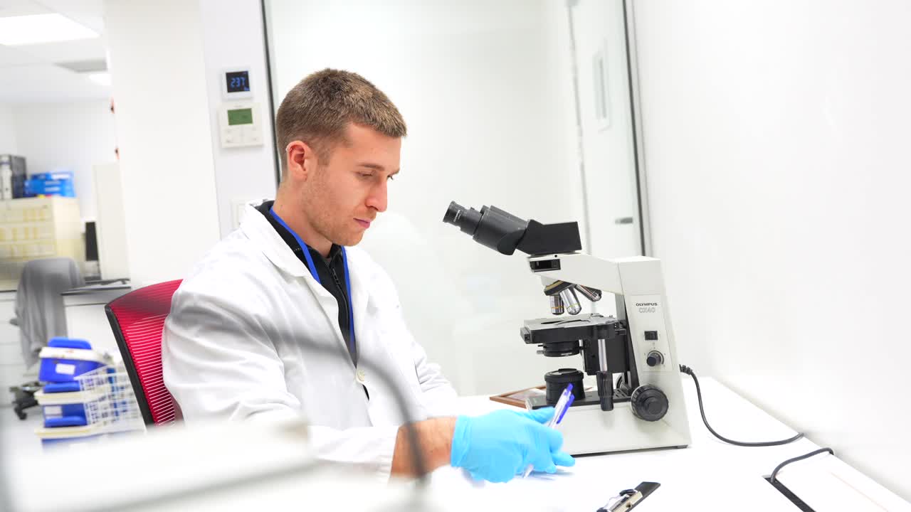 Scientist working with a microscope in a laboratory