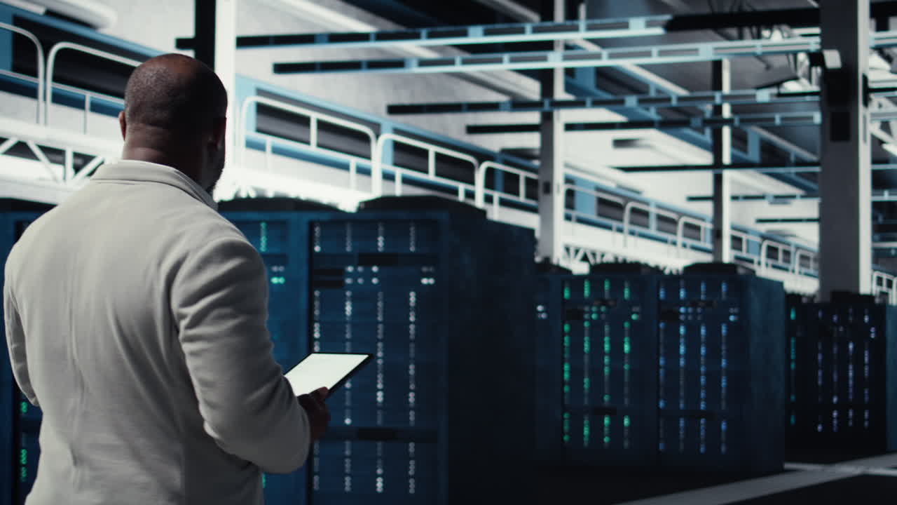 Vertical video Data center system administrator checks infrastructure diagnostics using tablet