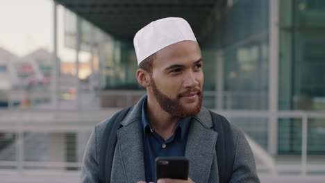 portrait of young muslim man using smartphone texting businessman in city