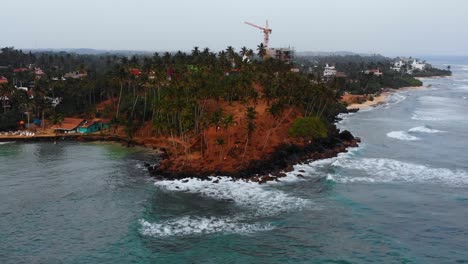 Coconut-Tree-Hill-on-Mirissa-Beach-in-Sri-Lanka,-Tourism-Travel-Destination---Aerial