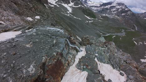 flying through rocky hiking mountains of fellaria glacier in sondrio province, lombardy, italy, europe