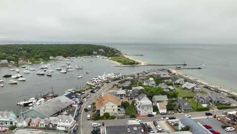 establishing drone shot of the oak bluffs downtown area with the marina in the background