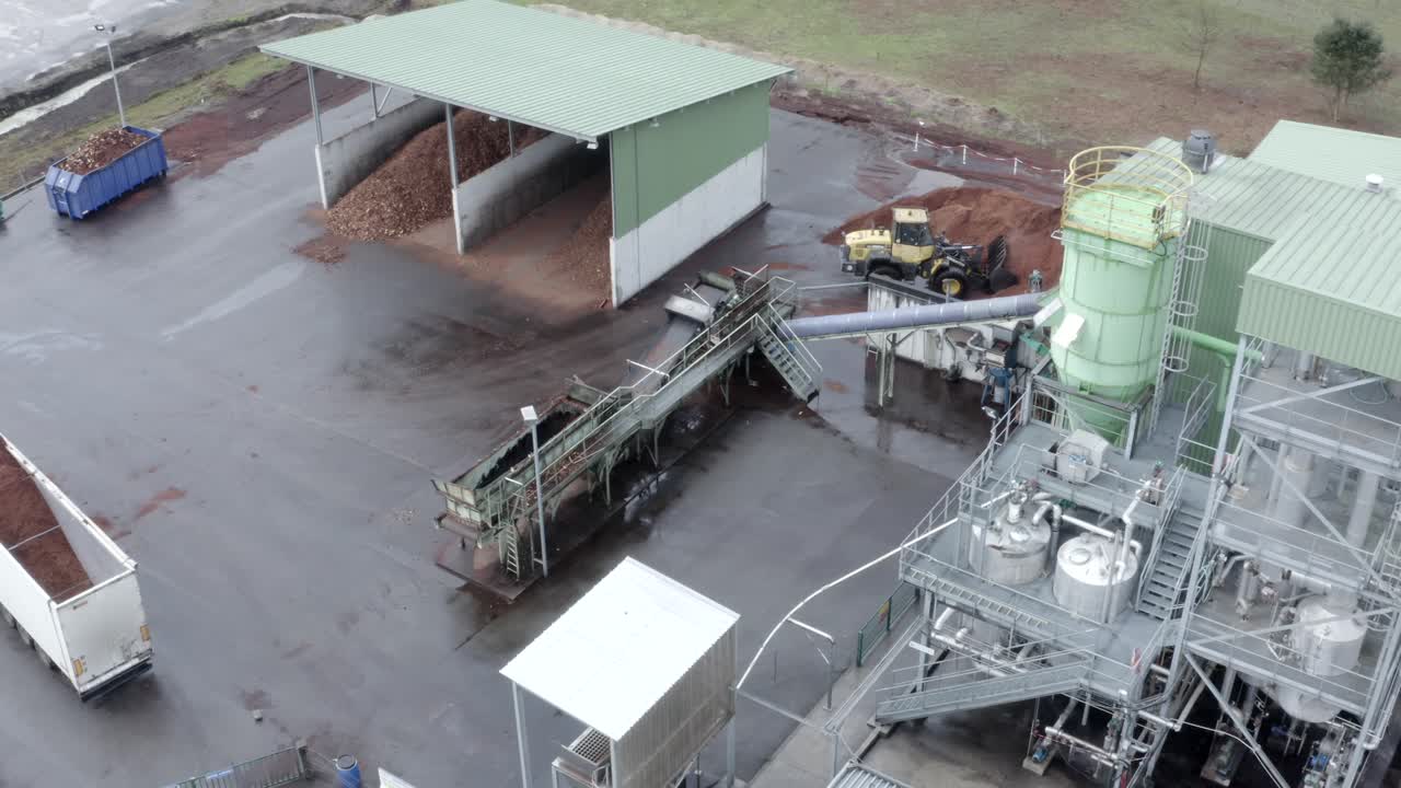 Aerial drone view looking directly down onto rooftops and sections of the DRT Factory, showcasing its industrial layout in Veille-Saint-Girons, France