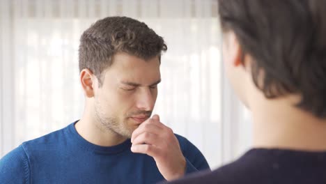 bad breath. the man is bothered by bad breath.