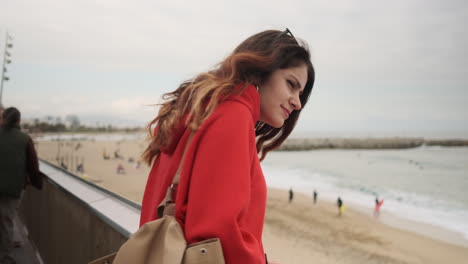 Young-girl-looking-at-something-on-the-seafront