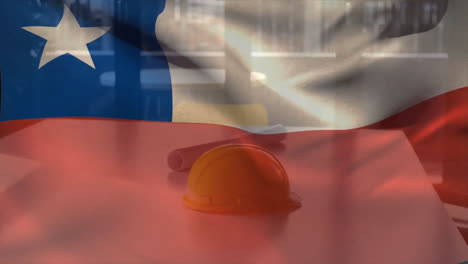 animación de la bandera de chile ondeando sobre casco amarillo y plano de piso en la mesa contra una ventana de vidrio