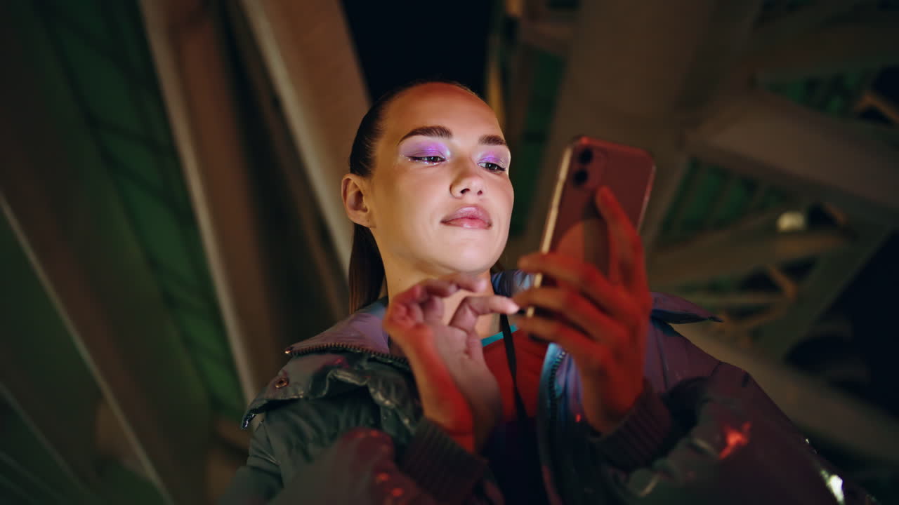 Trendy girl typing phone at night close up. Woman search information smartphone.