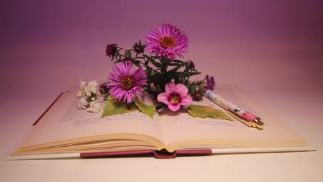 close up of flowers and pen on the book