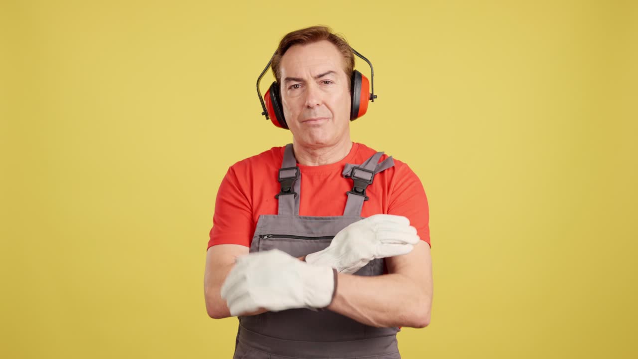 Professional worker in safety gear with arms crossed