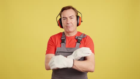 professional worker in safety gear with arms crossed