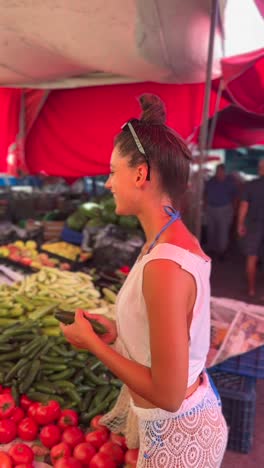 woman shopping for vegetables at a market