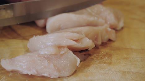 motion controlled shot of cutting chicken meat