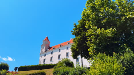 beautiful greenery grows around the old bratislava castle in slovakia. low angle view at the famous landmark on sunny day