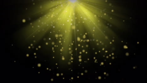 animation of yellow spots and bright light spot against black background with copy space